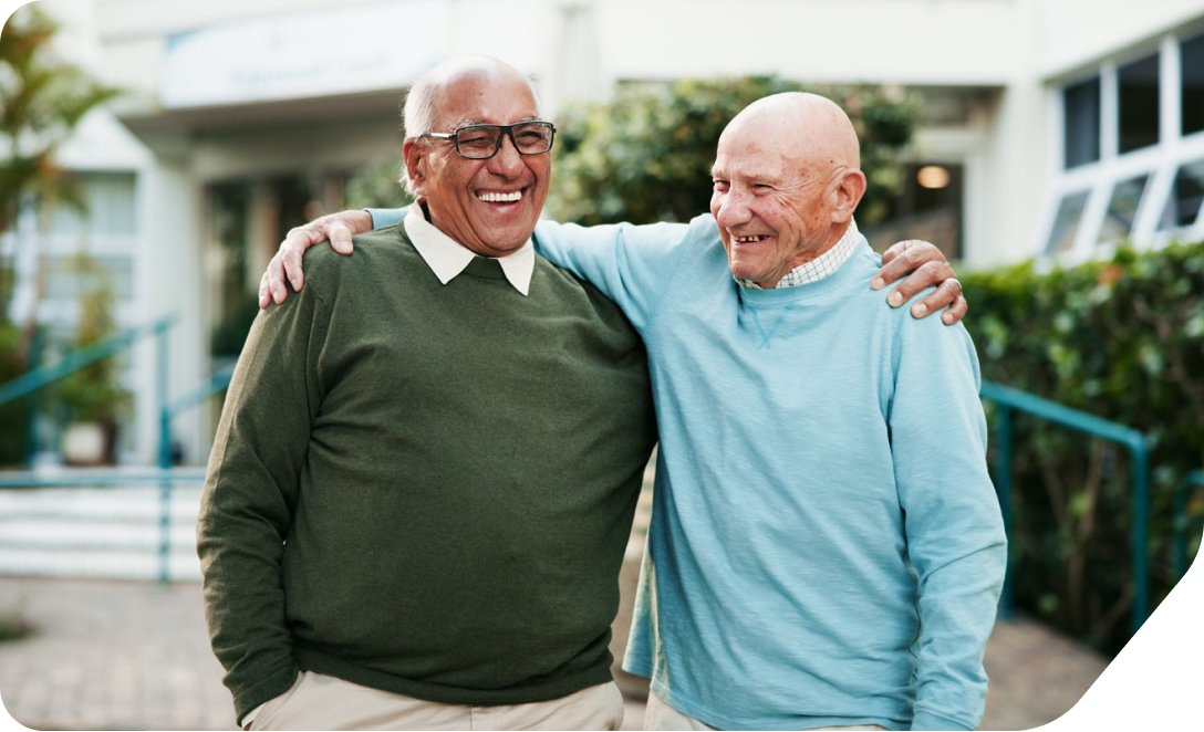 An elderly man talking to his neighbor over the fence