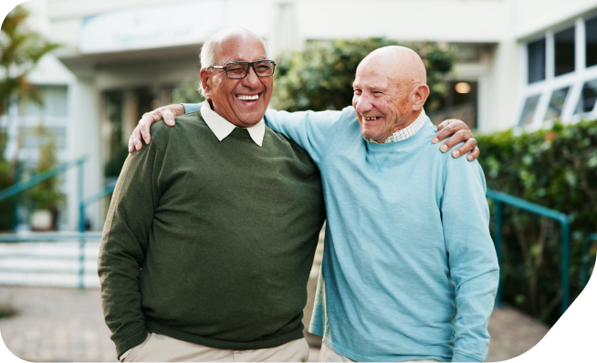 An elderly man talking to his neighbor over the fence